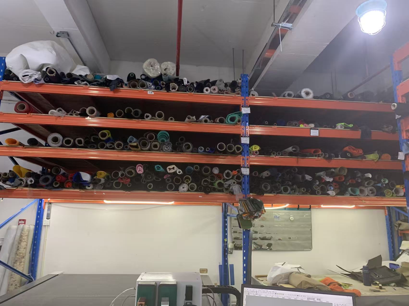 Rolls of TPU-coated nylon and PVC tarpaulin in a waterproof bag factory material store